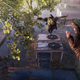 A screenshot from Dying Light 2 depicting protagonist Aiden Caldwell jumping onto an air vent with fellow freerunner Hakon.